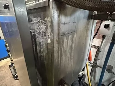 Original leaking water tank on Nilfisk Delta Booster multi-pump pressure washer system before replacement.